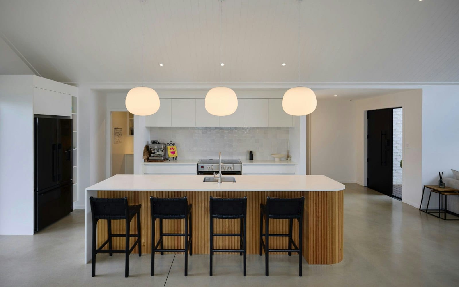 Open-plan kitchen with island bench, pendant lighting and walk-in scullery in a Signature Homes build