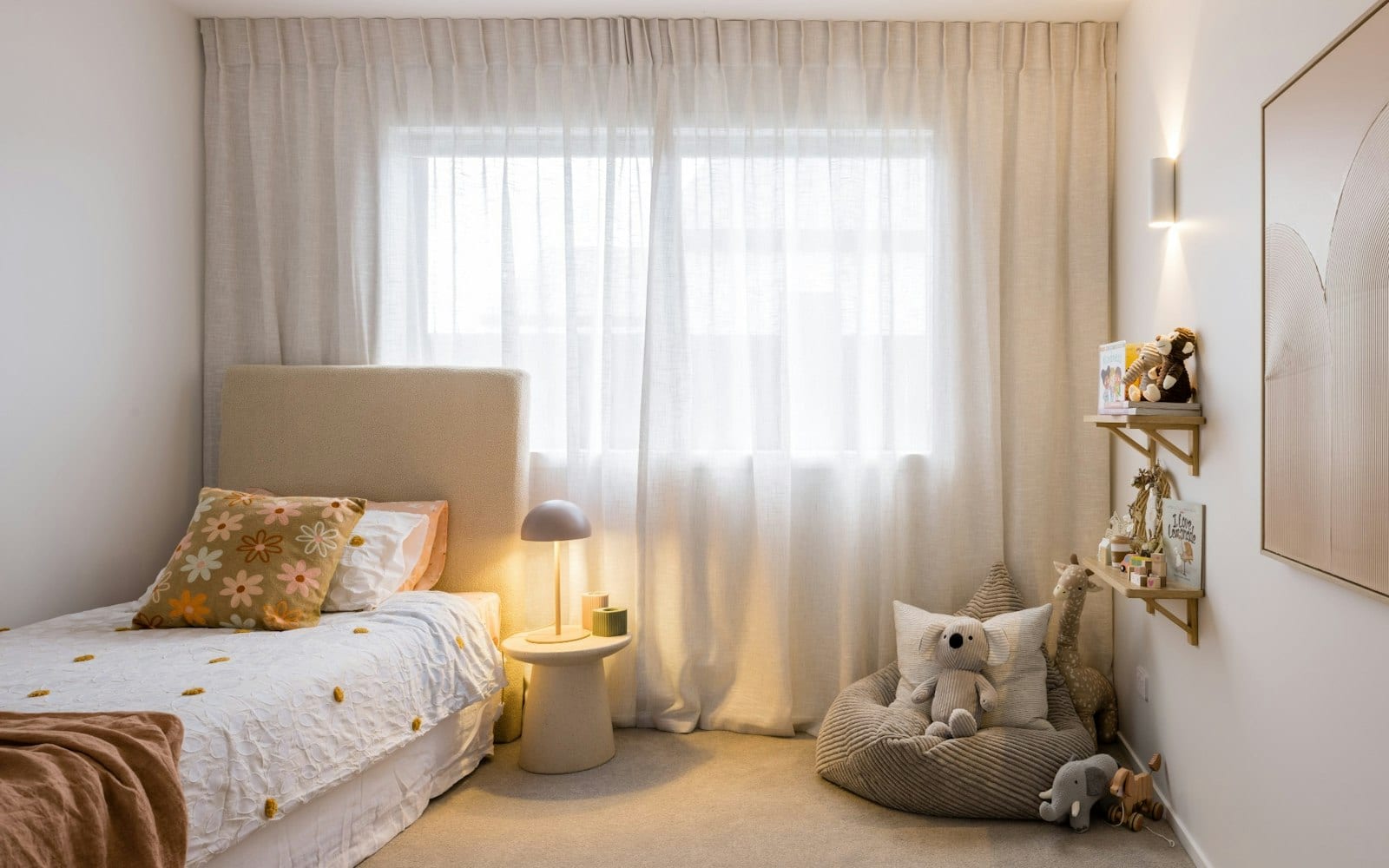 Child's bedroom with soft natural light and built-in shelving in a Signature Homes build