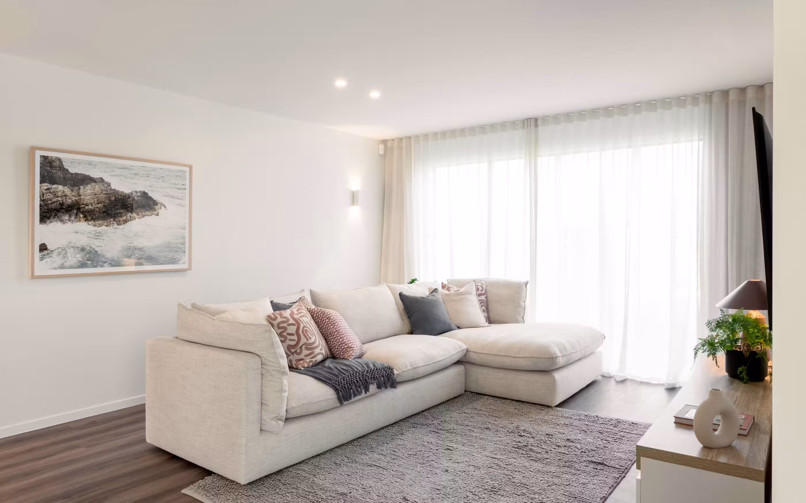 Natural light, soft textures and neutral finishes create a fresh and welcoming contemporary living space.