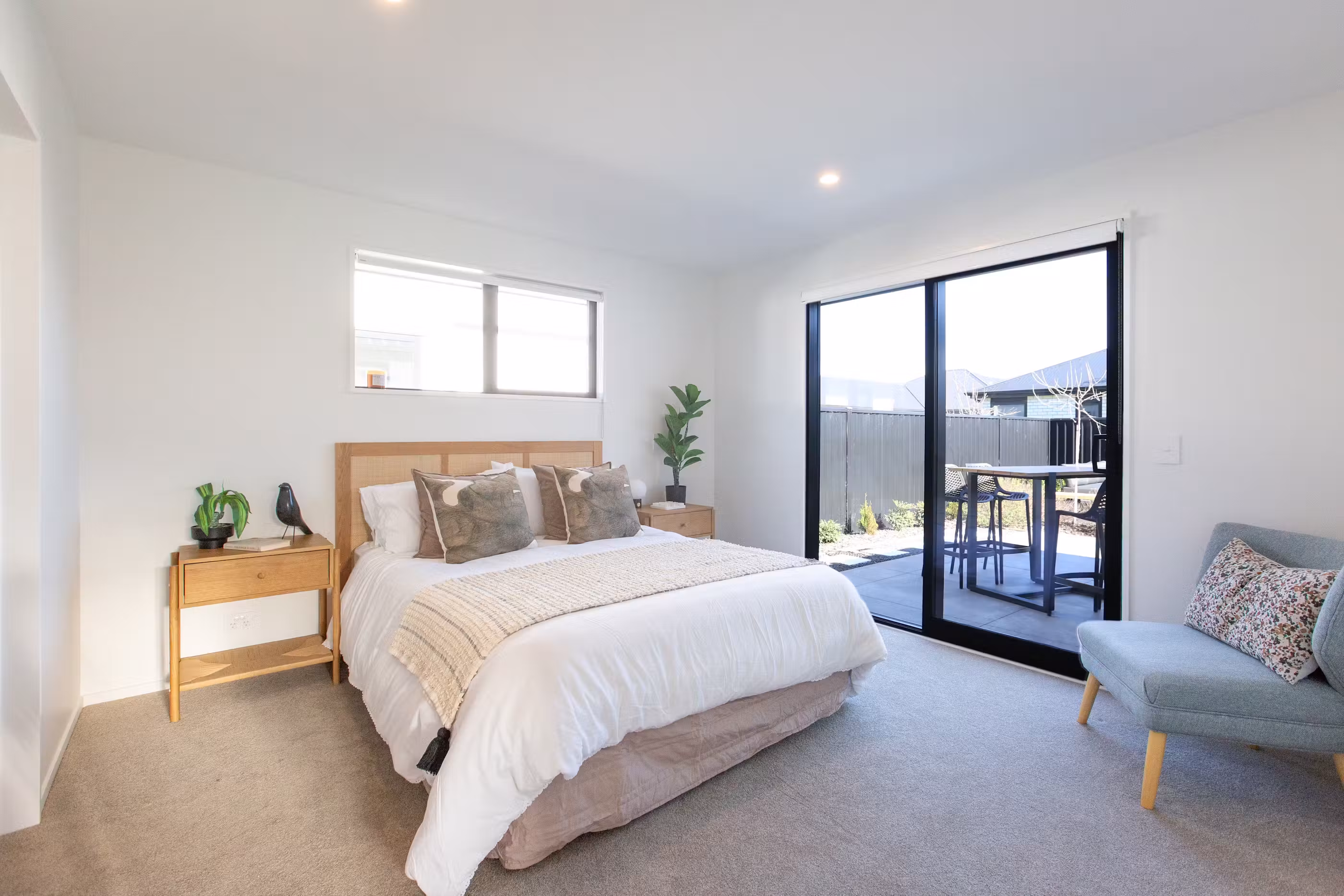 A spacious, light-filled bedroom with modern finishes and seamless access to outdoor living.